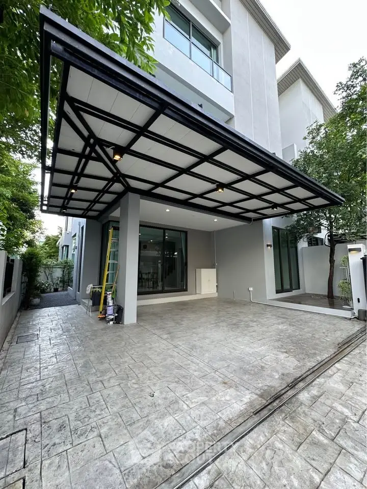 Modern residential building with spacious covered parking area and sleek design.