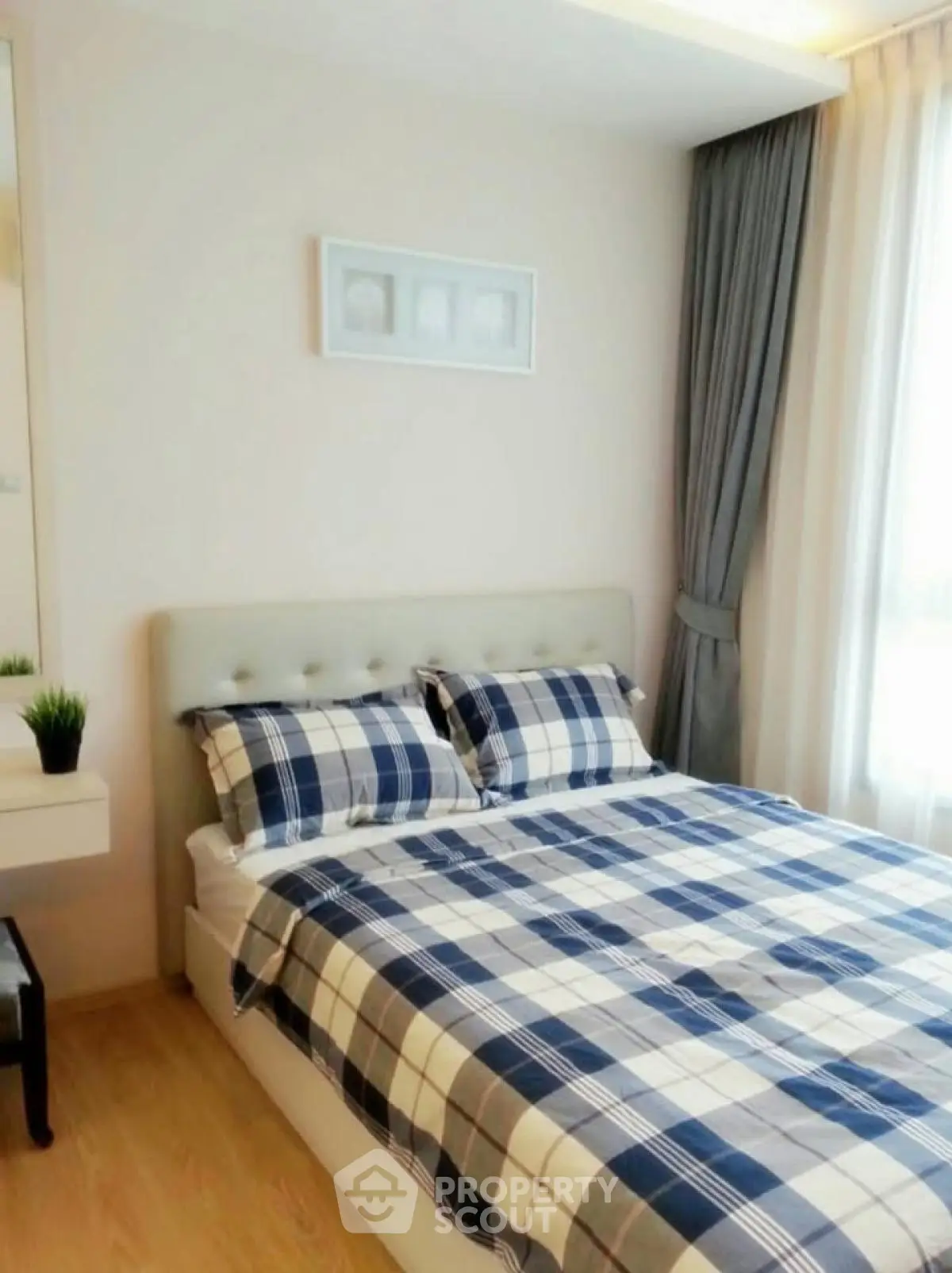 Cozy bedroom with plaid bedding and natural light