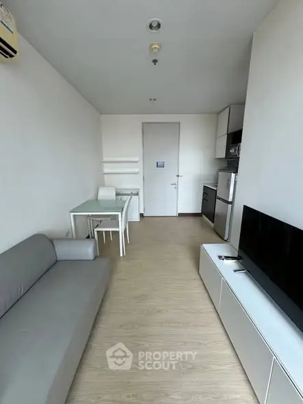 Modern living room with sleek furniture and open kitchen layout