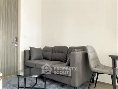 Modern living room with stylish gray sofa and sleek furniture