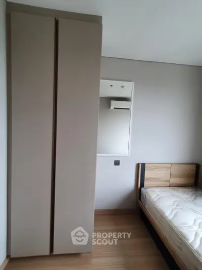 Modern bedroom with sleek wardrobe and minimalist bed design