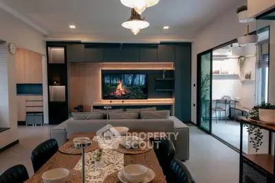 Modern living room with stylish decor and open layout, featuring a cozy dining area and large TV display.