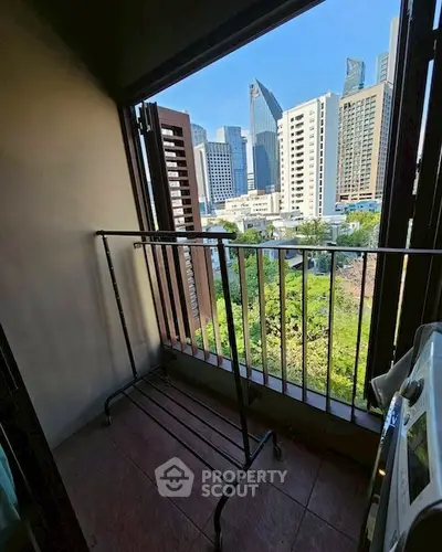 Urban balcony with city skyline view, perfect for enjoying the vibrant cityscape.