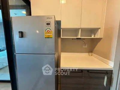 Modern kitchen with sleek fridge and ample storage space