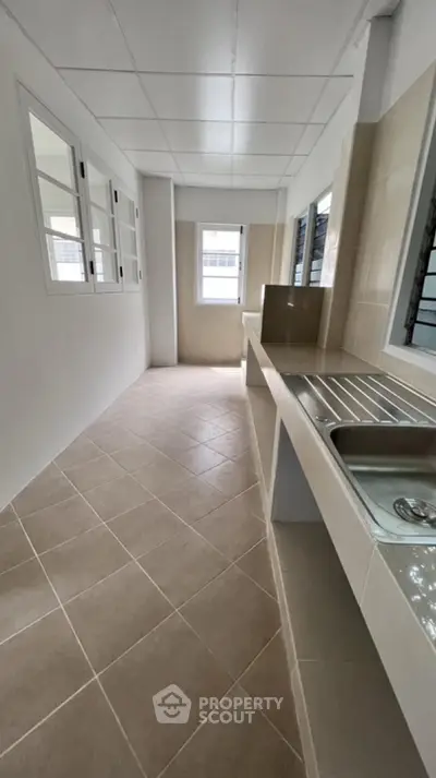 Spacious kitchen with sleek countertops and ample natural light