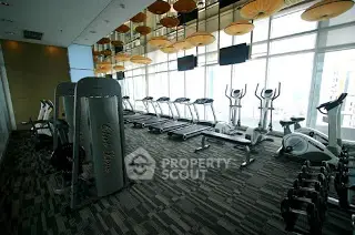 Modern gym with state-of-the-art equipment and panoramic city views.