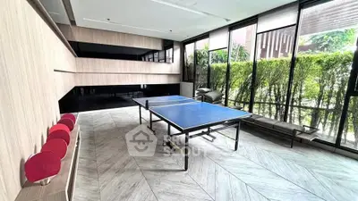 Spacious recreational area with ping pong table and lush greenery view