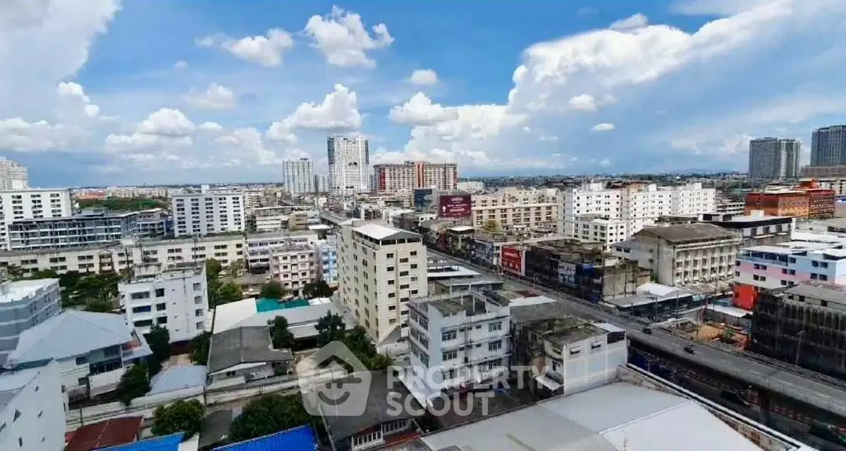 Stunning cityscape view from a high-rise building showcasing urban skyline and vibrant city life.