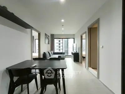 Modern open-plan living and dining area with sleek furniture and natural light.