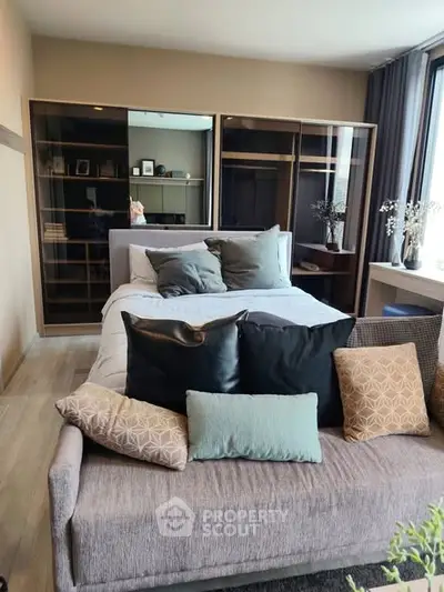 Modern bedroom with stylish decor and large windows for natural light