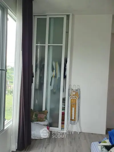 Cozy bedroom corner with wardrobe and window view