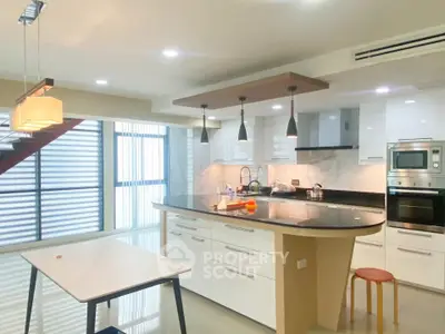 Modern kitchen with island, sleek cabinetry, and built-in appliances in a stylish open layout.
