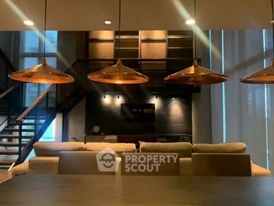 Luxurious modern living room with stylish lighting and elegant staircase