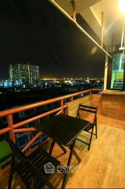 Stunning night view from a spacious balcony with city lights panorama.