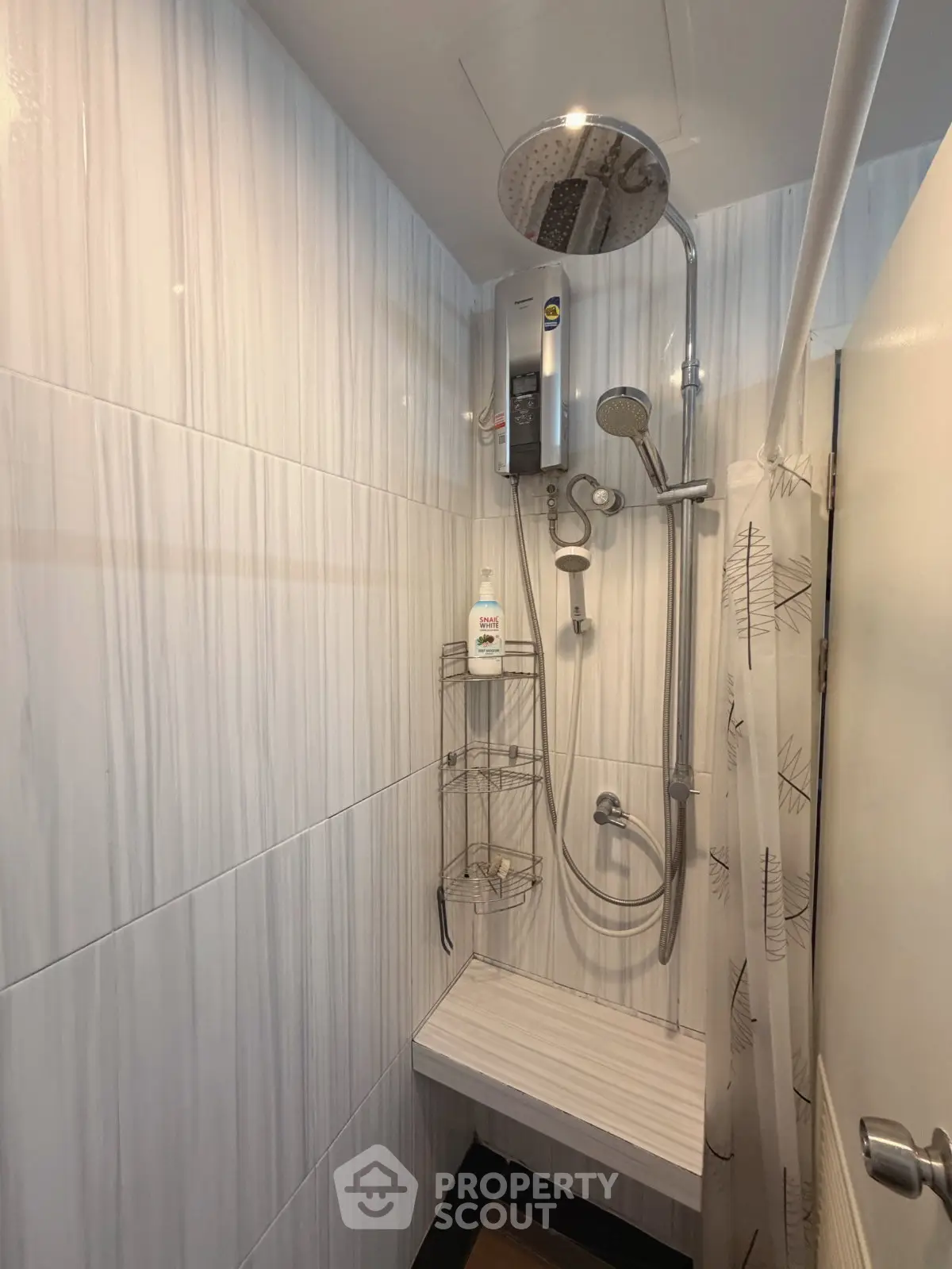 Modern bathroom with sleek shower fixtures and elegant tile design, perfect for a contemporary home.