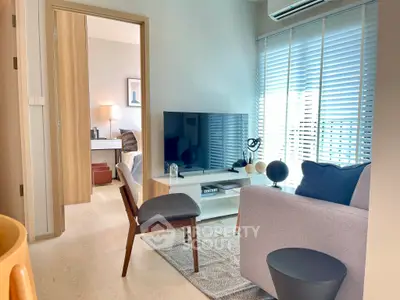 Modern living room with sleek furniture and natural light in a stylish apartment.
