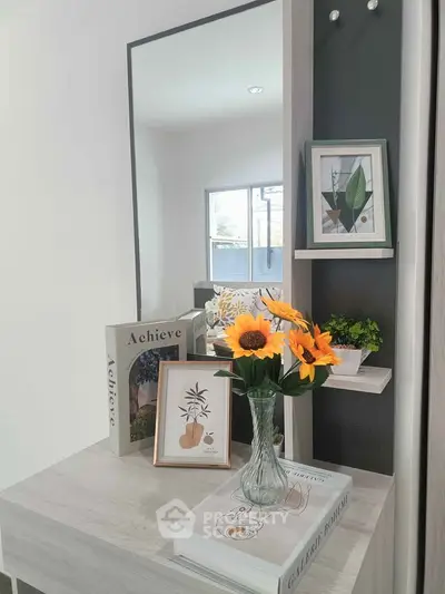 Stylish interior decor with sunflowers and modern art in a bright living space.