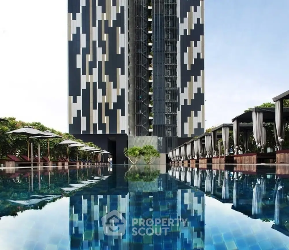 Stunning modern building with luxurious poolside cabanas and reflective water surface.