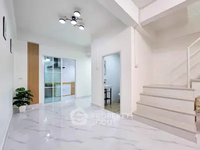 Spacious modern interior with marble flooring and stylish lighting, perfect for contemporary living.