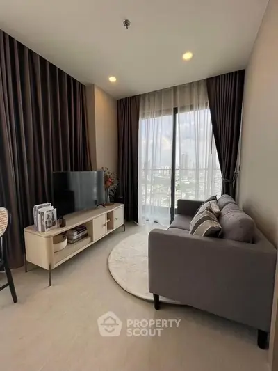 Modern living room with city view, stylish furniture, and natural light.