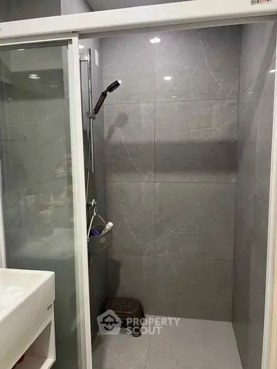 Modern bathroom with sleek shower and elegant gray tiles