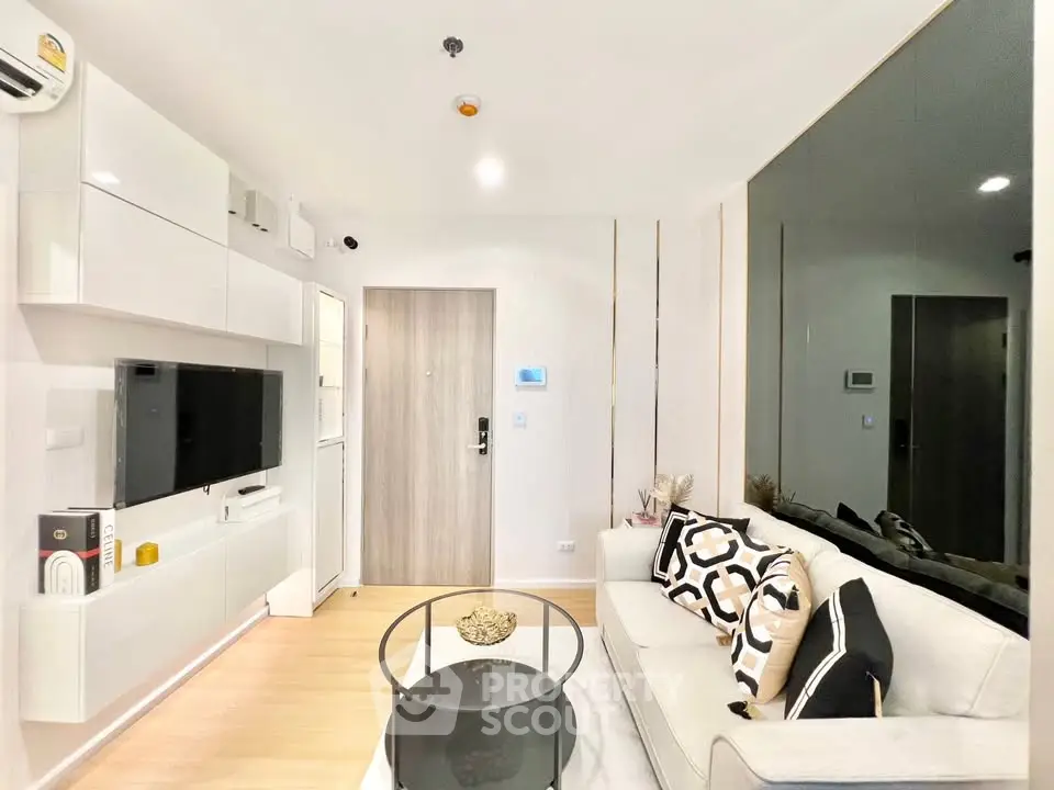 Modern living room with sleek white furniture and stylish decor