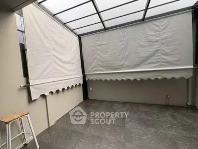 Spacious covered balcony with modern design and tiled flooring