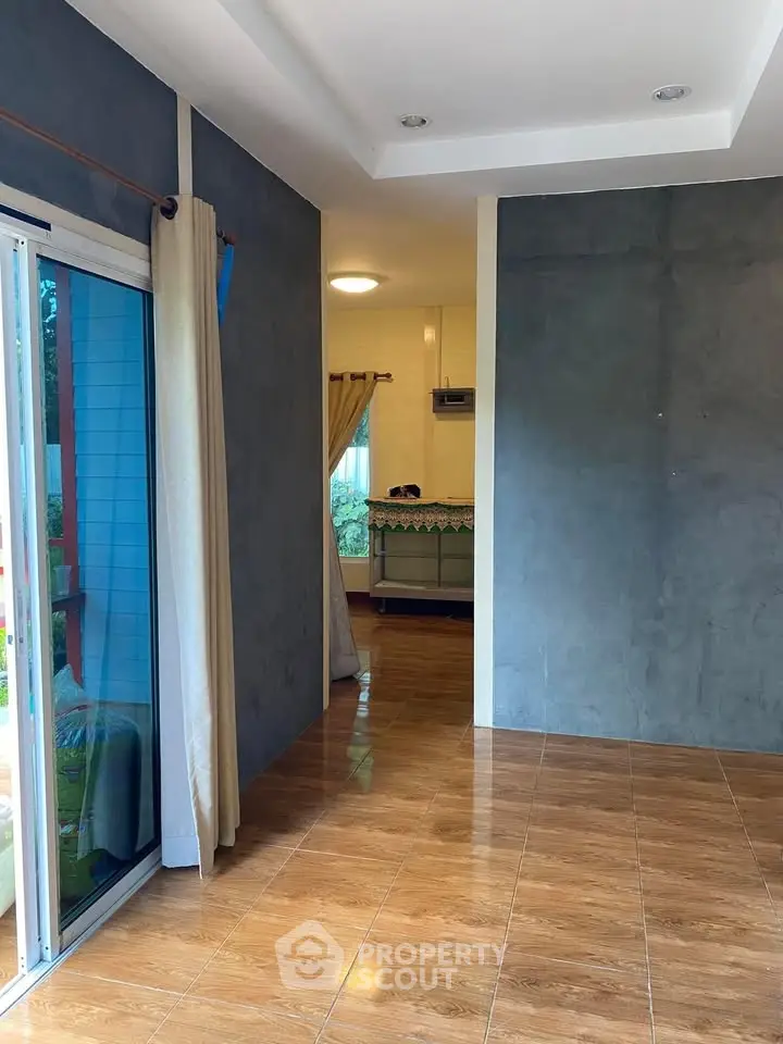 Spacious interior with sliding glass doors and wooden flooring