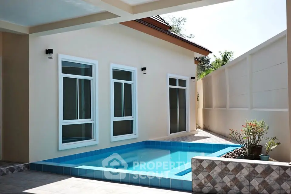 Charming residential property with a private pool and modern exterior design.