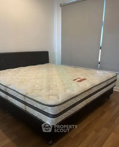 Spacious bedroom with a comfortable bed and modern decor, perfect for relaxation.