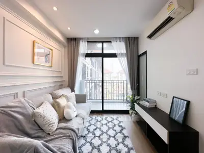 Modern living room with cozy decor and balcony access in stylish apartment.