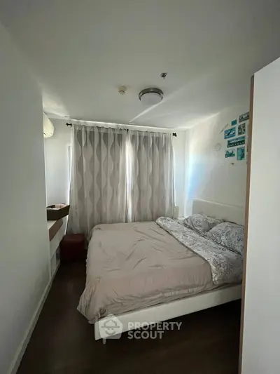 Cozy bedroom with natural light and modern decor in a stylish apartment.