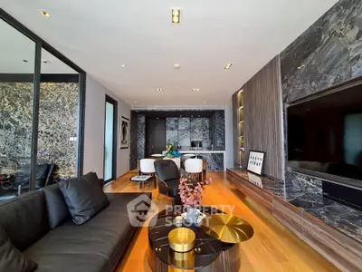 Luxurious modern living room with marble accents and sleek black furniture, perfect for stylish urban living.