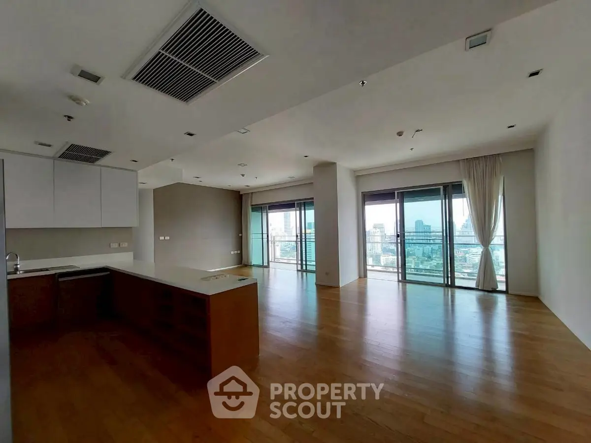 Spacious modern living room with city view and open kitchen layout