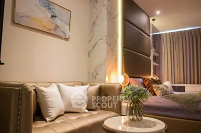 Luxurious modern bedroom with elegant decor and plush seating area.