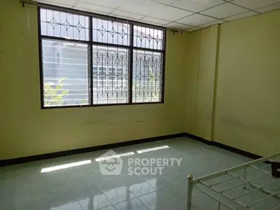 Spacious bedroom with large window and natural light, ideal for customization.
