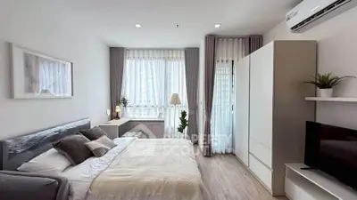 Spacious modern bedroom with natural light and stylish decor