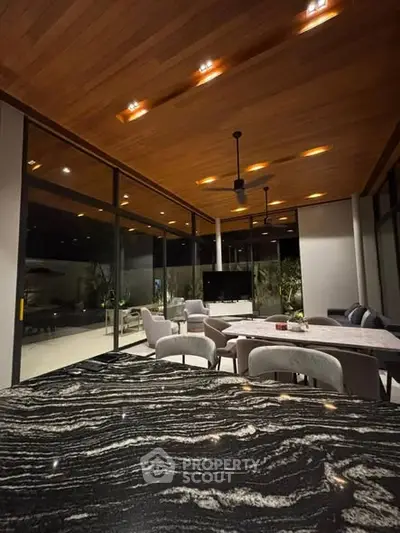 Luxurious modern living room with elegant marble countertops and expansive glass windows.