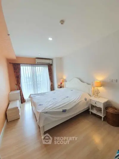 Spacious bedroom with elegant decor and natural light