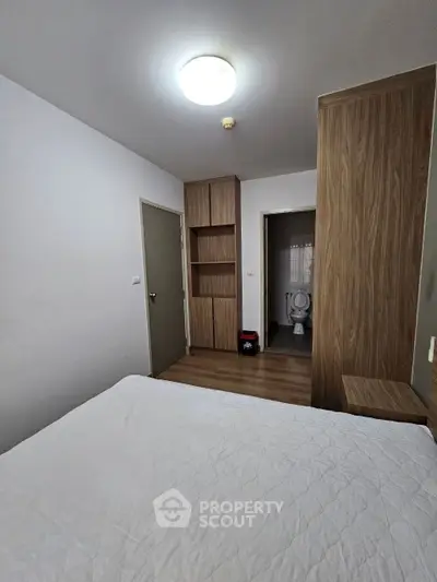 Cozy bedroom with built-in wooden wardrobe and ensuite bathroom