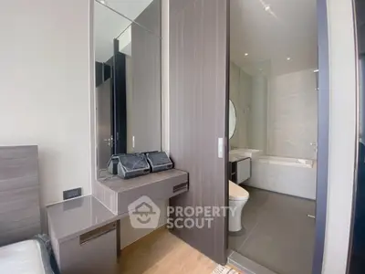 Modern bedroom with ensuite bathroom featuring sleek design and contemporary fixtures.