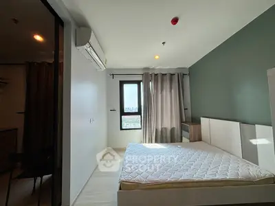 Modern bedroom with large window and city view, featuring minimalist design and ample natural light.