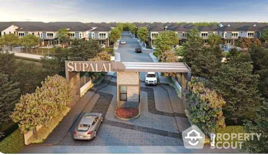 Stunning gated community entrance with modern design and lush landscaping