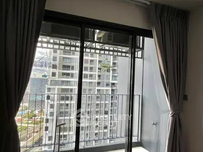 Modern apartment balcony with city view and glass doors