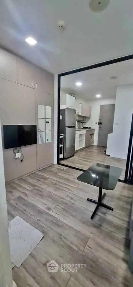 Modern open-layout living room with sleek kitchen and stylish flooring