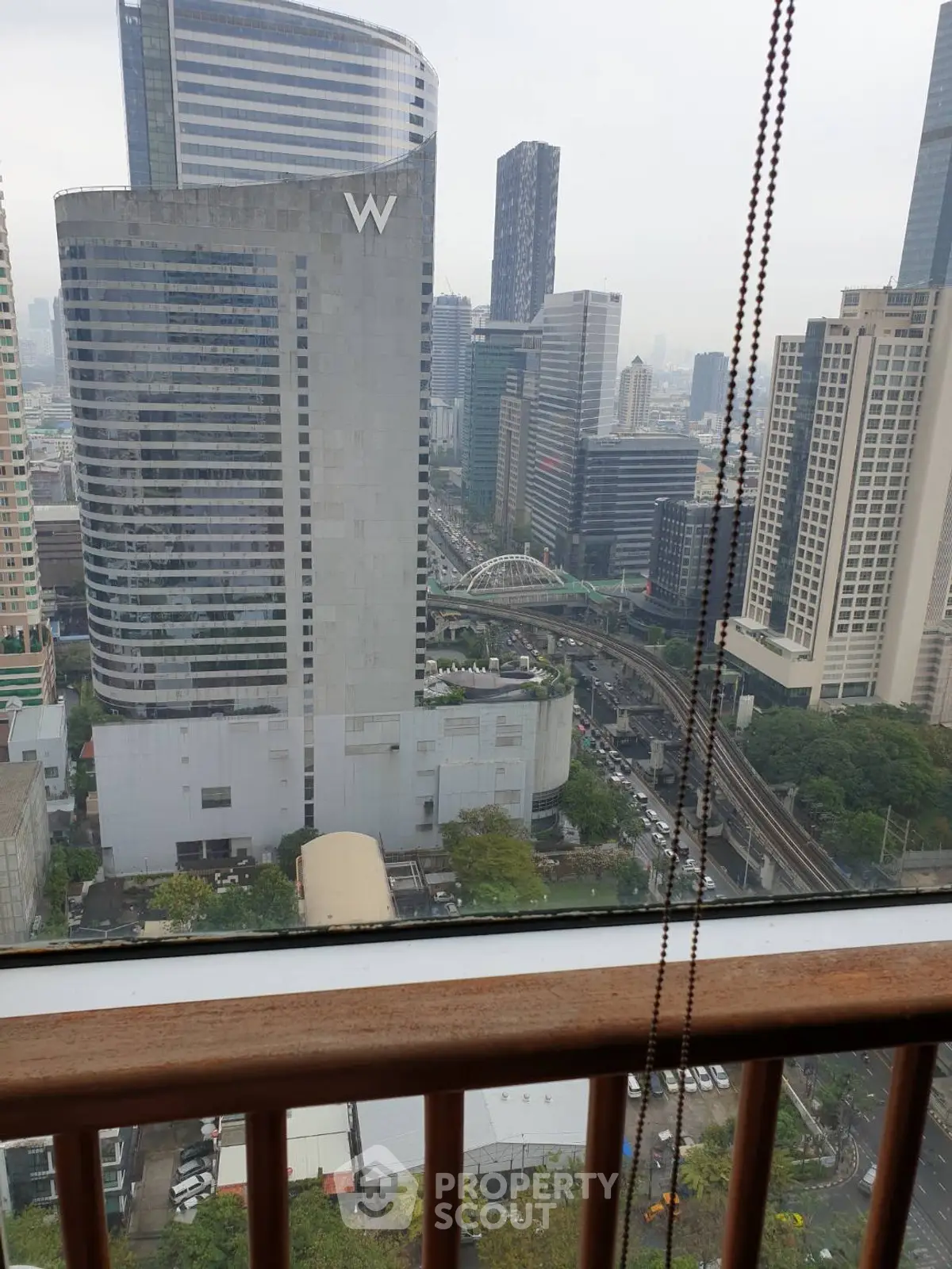 Stunning cityscape view from high-rise balcony with modern skyscrapers.