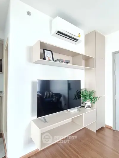 Modern living room with sleek TV unit and air conditioning, perfect for comfortable living.