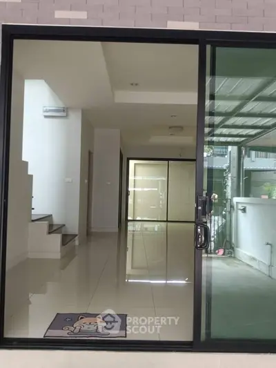 Spacious modern interior with sliding glass doors and sleek tiled flooring