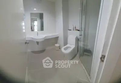 Modern bathroom with sleek fixtures and spacious shower area.