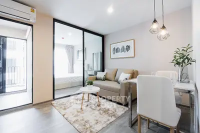 Modern living room with cozy decor and open layout to bedroom
